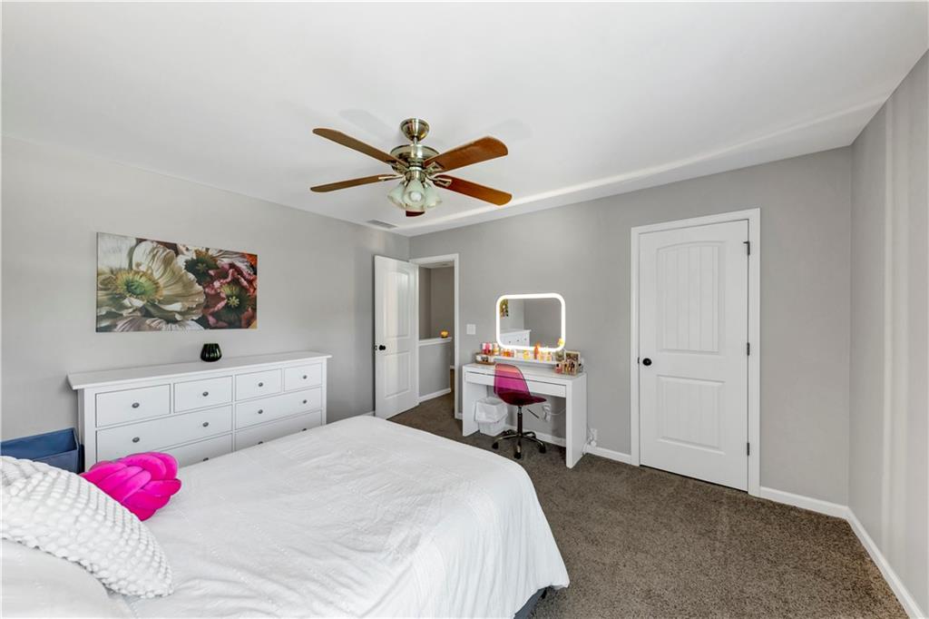 210 Creek View Lane Acworth, GA 30102 - Photo 30 of 48 a bedroom with a bed a chandelier and a closet