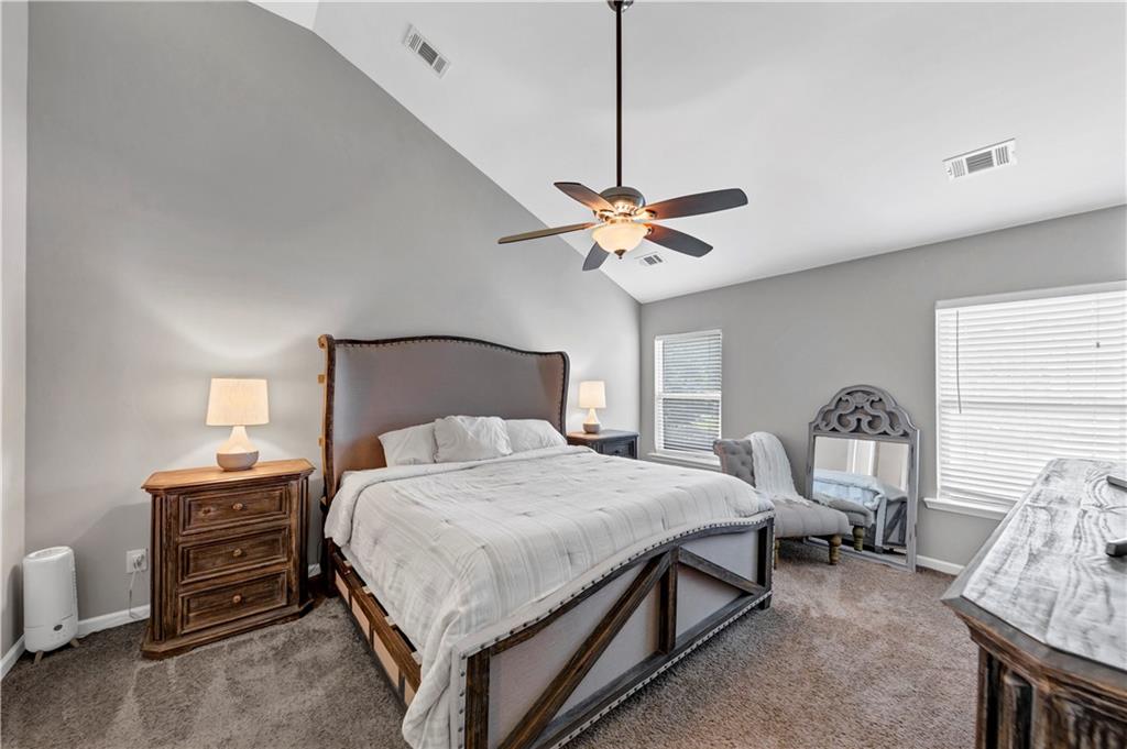 210 Creek View Lane Acworth, GA 30102 - Photo 32 of 48 a bedroom with a bed chandelier and a window