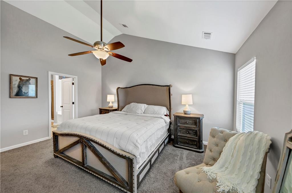 210 Creek View Lane Acworth, GA 30102 - Photo 33 of 48 a bedroom with a bed chandelier and a window