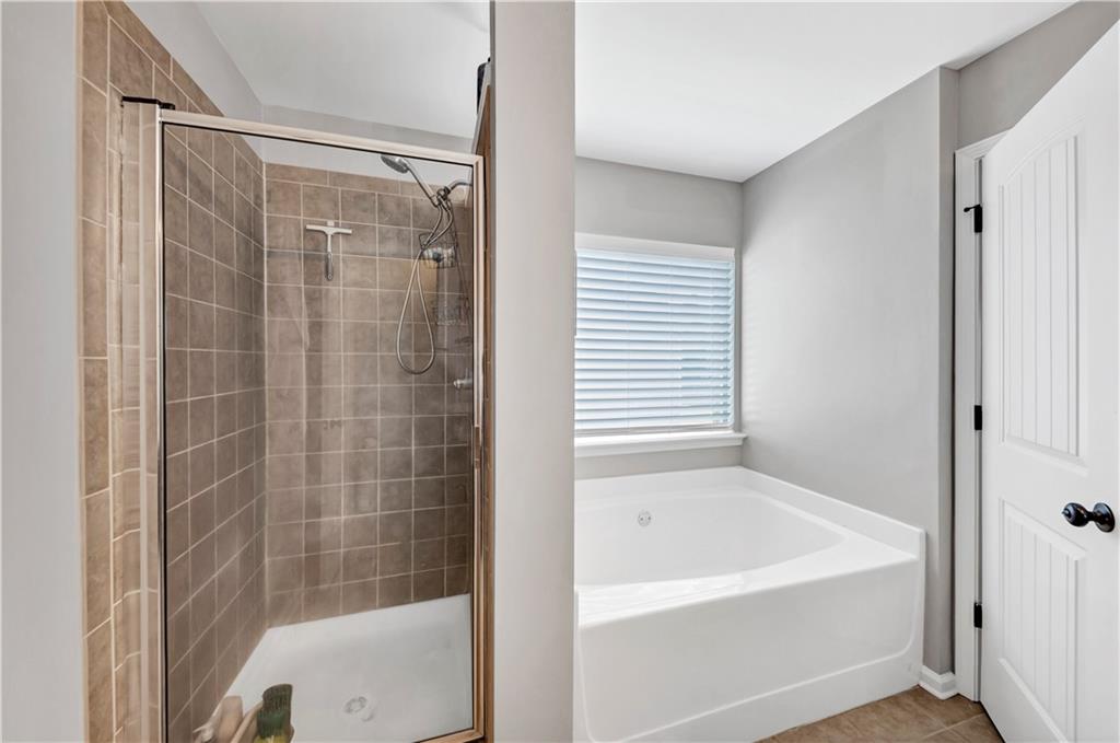 210 Creek View Lane Acworth, GA 30102 - Photo 37 of 48 a bathroom with a bathtub and a shower