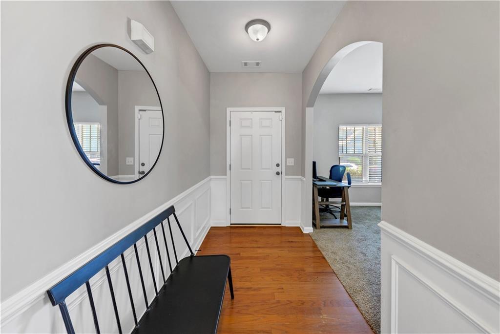 210 Creek View Lane Acworth, GA 30102 - Photo 4 of 48 a view of a hallway with wooden floor and a dining room
