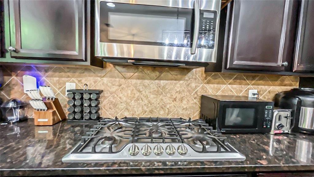 3281 Alhambra Circle Hampton, GA 30228 - Photo 26 of 88 a kitchen with an oven a stove and a microwave oven