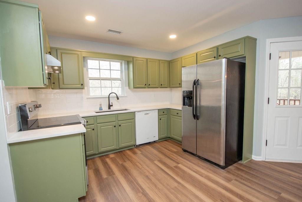75 Bretts Bend Sharpsburg, GA 30277 - Photo 11 of 39 a kitchen with a refrigerator sink and cabinets