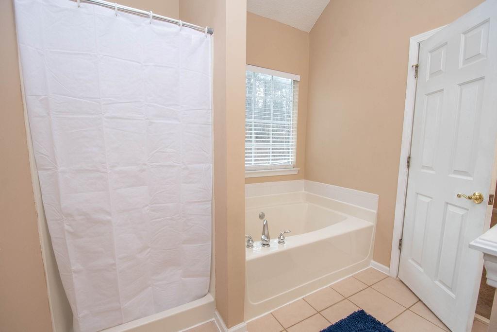 75 Bretts Bend Sharpsburg, GA 30277 - Photo 18 of 39 a white bath tub sitting next to a window