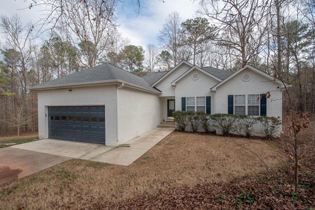 75 Bretts Bend Sharpsburg, GA 30277 - Photo 2 of 39 a front view of a house with a yard and garage