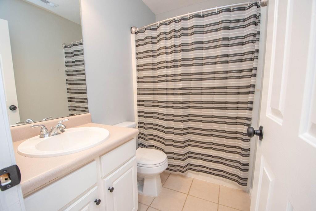75 Bretts Bend Sharpsburg, GA 30277 - Photo 22 of 39 a bathroom with a sink a toilet and shower curtain