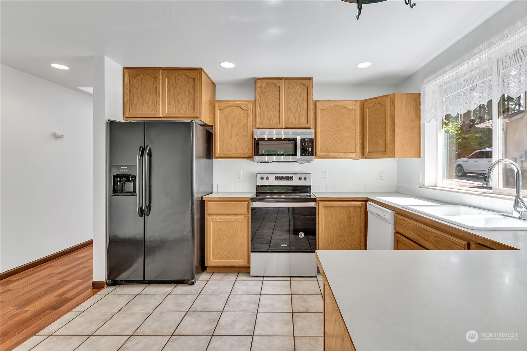 17545 Loop Lane Southeast Yelm, WA 98597 - Photo 11 of 35 a kitchen with stainless steel appliances granite countertop a refrigerator and a sink