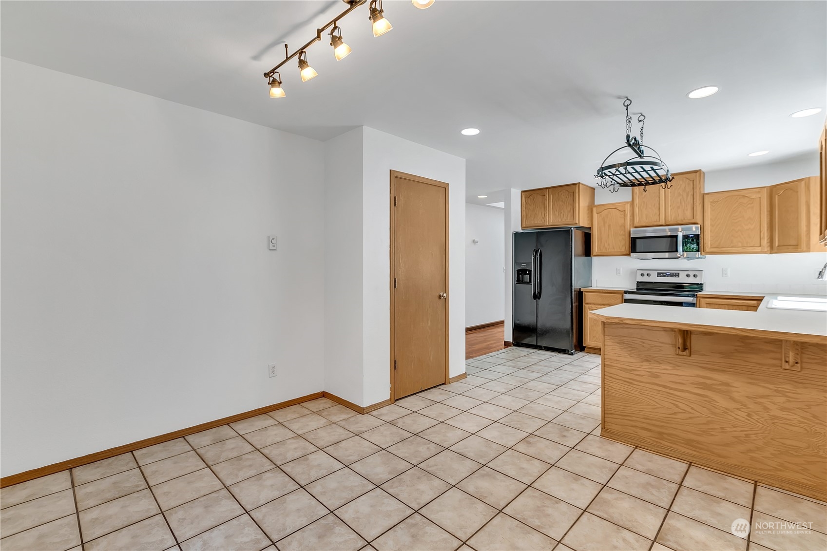 17545 Loop Lane Southeast Yelm, WA 98597 - Photo 14 of 35 a kitchen with granite countertop a refrigerator and a stove top oven