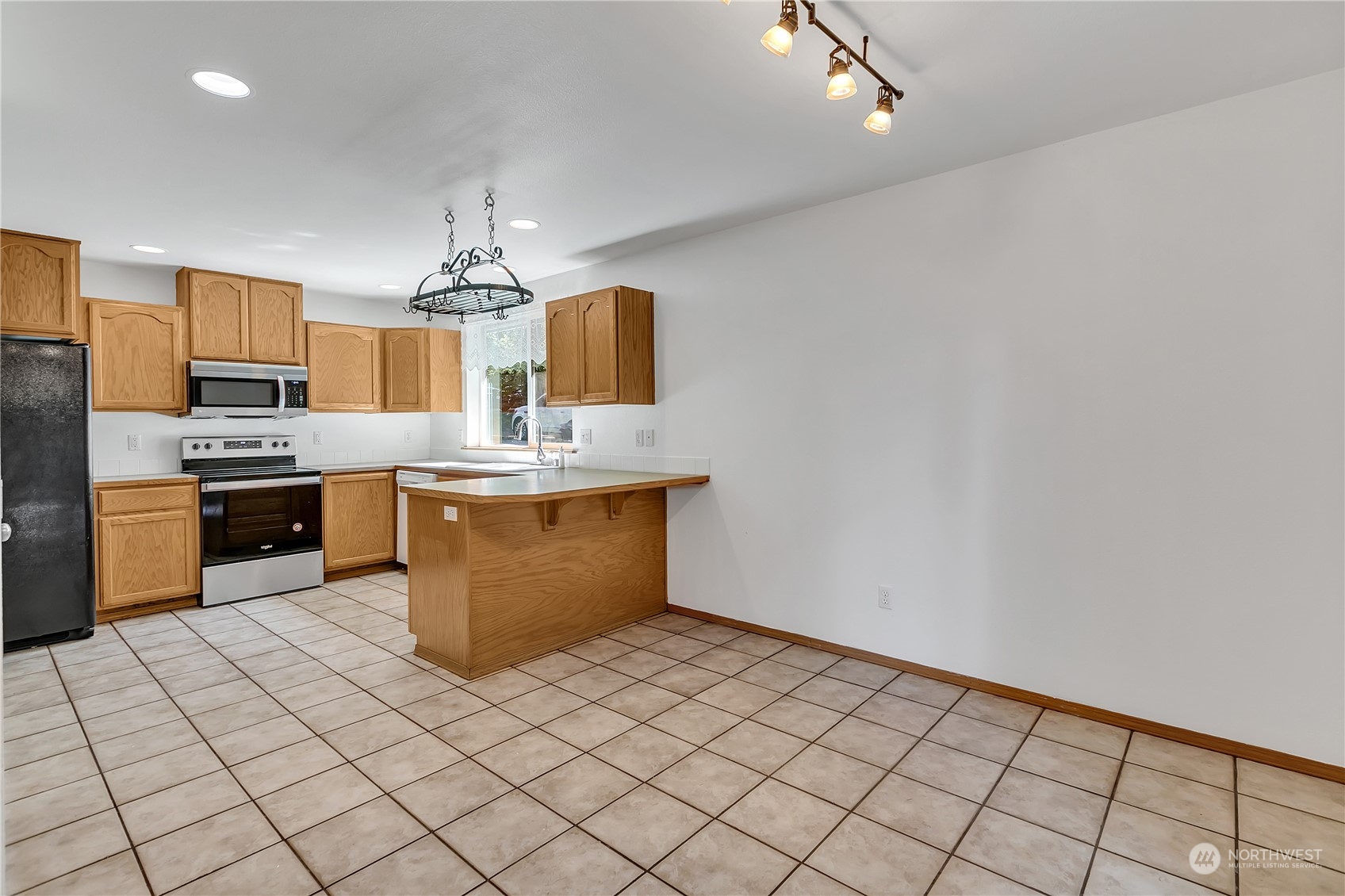 17545 Loop Lane Southeast Yelm, WA 98597 - Photo 15 of 35 a kitchen with stainless steel appliances granite countertop a sink counter top space cabinets and stainless steel appliances