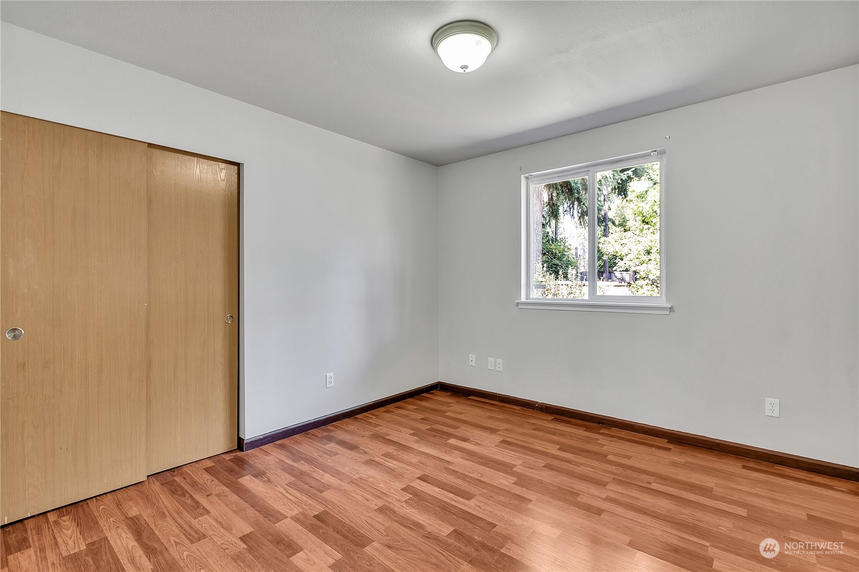 17545 Loop Lane Southeast Yelm, WA 98597 - Photo 25 of 35 an empty room with wooden floor and window