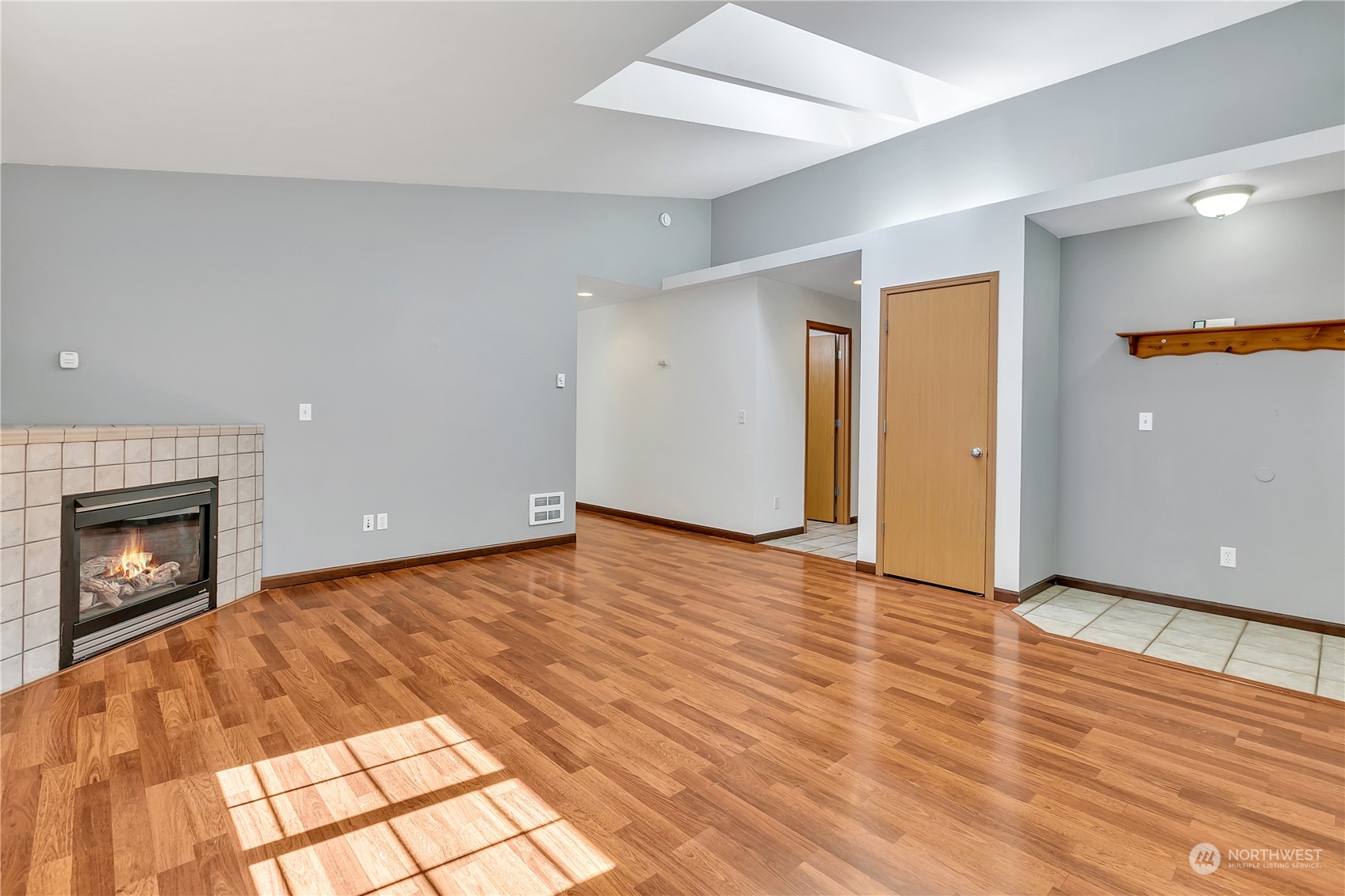 17545 Loop Lane Southeast Yelm, WA 98597 - Photo 7 of 35 a view of an empty room with wooden floor fireplace and a window