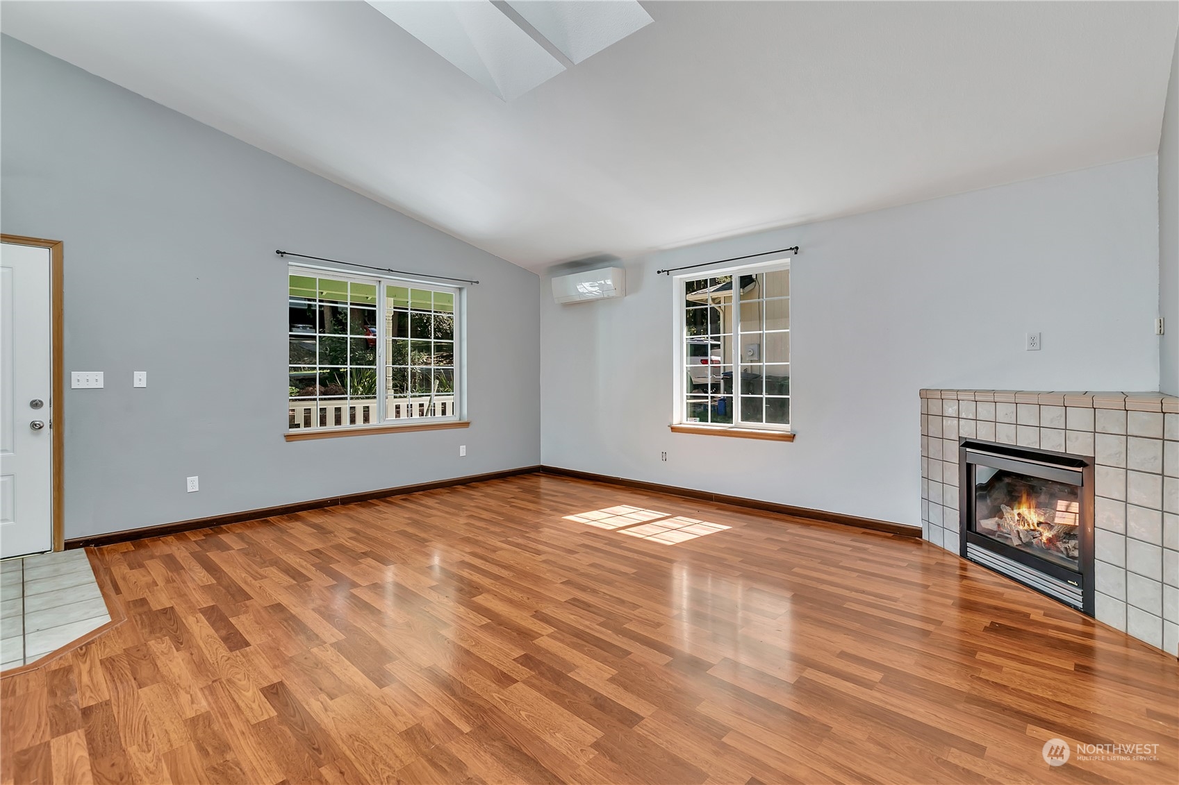 17545 Loop Lane Southeast Yelm, WA 98597 - Photo 8 of 35 a view of an empty room with wooden floor fireplace and a window