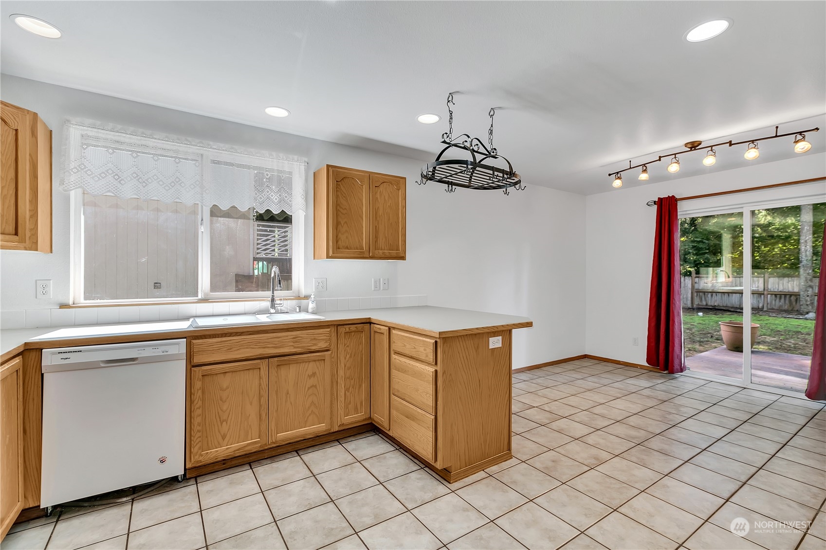 17545 Loop Lane Southeast Yelm, WA 98597 - Photo 9 of 35 a kitchen with stainless steel appliances granite countertop a sink and a refrigerator