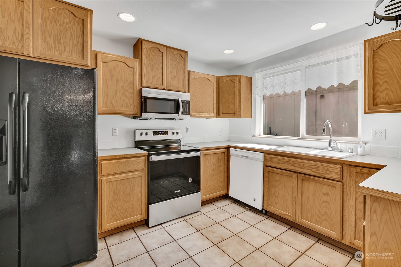 17545 Loop Lane Southeast Yelm, WA 98597 - Photo 10 of 35 a kitchen with stainless steel appliances granite countertop a refrigerator sink and cabinets