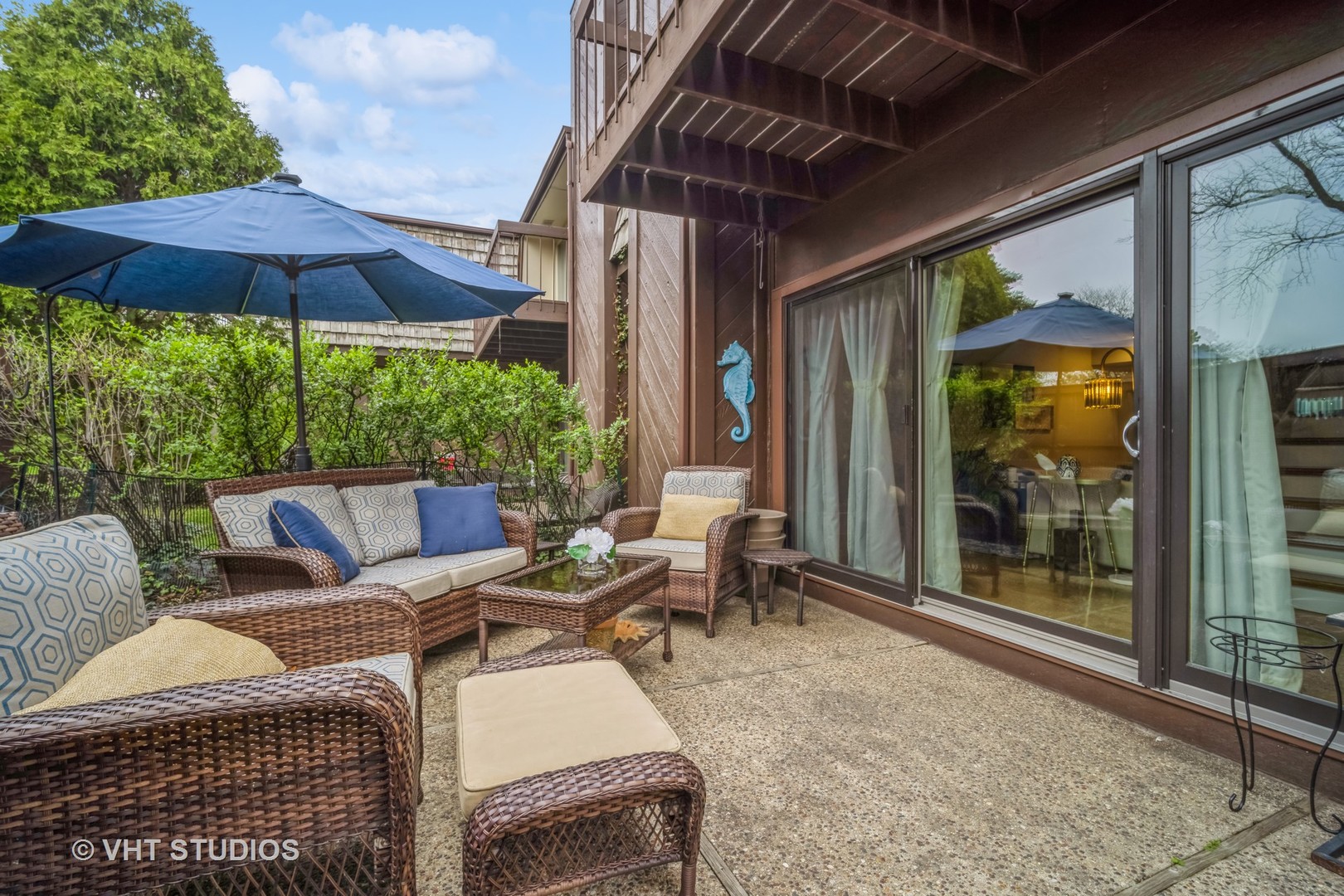 1557 Winnetka Road Glenview, IL 60025 - Photo 21 of 21 a view of a patio with couches table and chairs under an umbrella with a small yard