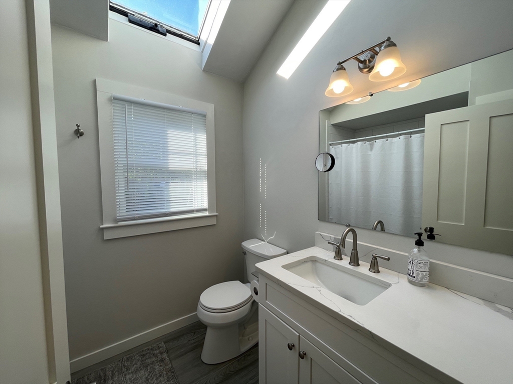 91 Martin Street Wareham, MA 02532 - Photo 17 of 25 a bathroom with a toilet sink and mirror