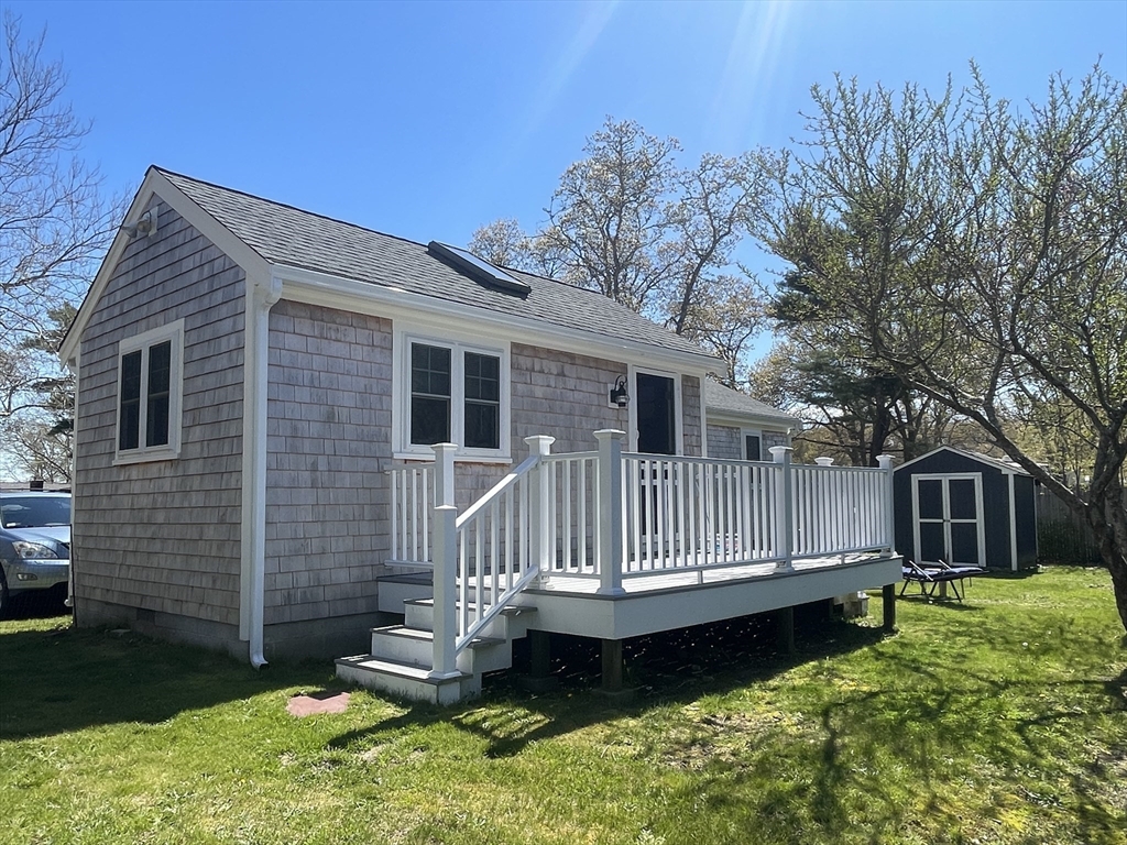 91 Martin Street Wareham, MA 02532 - Photo 3 of 25 a view of a house with a wooden deck and a yard
