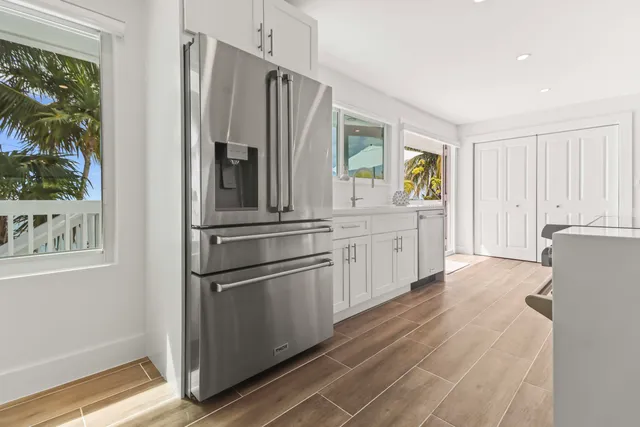 a kitchen with stainless steel appliances a refrigerator sink and cabinets