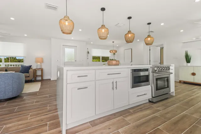 a living room with lots of furniture and kitchen view