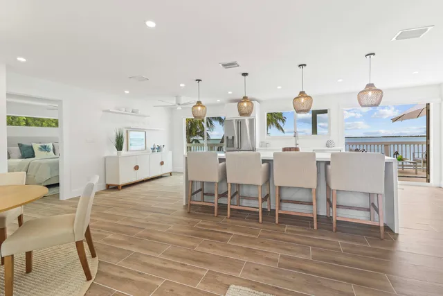 a living room with lots of furniture and kitchen view
