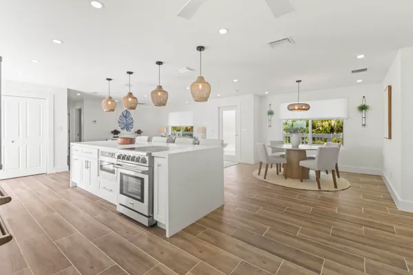 a front view of a house with a garden and potted plants