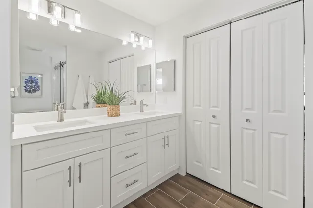 a bathroom with a double vanity sink and mirror