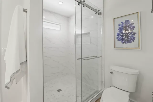 a bathroom with a toilet and a shower