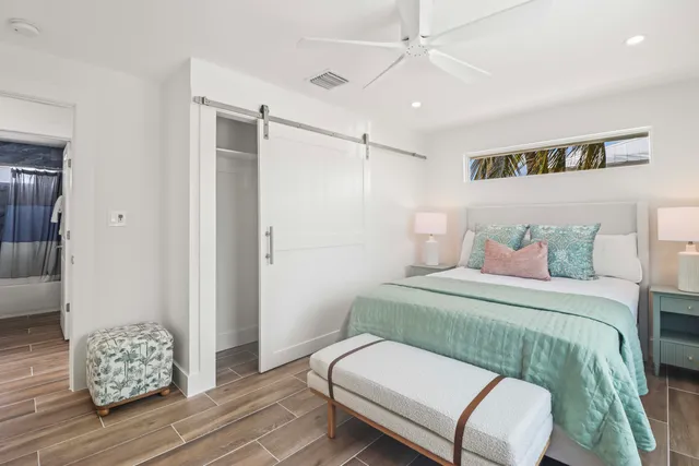 a bedroom with a bed and a chair