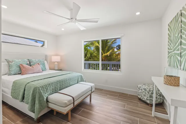 a bedroom with a bed window and a table