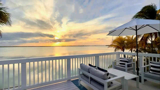 a view of a roof deck with furniture and a umbrella
