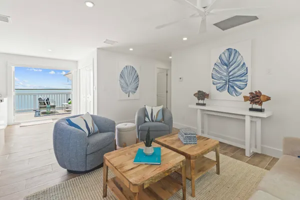 a living room with lots of furniture and kitchen view
