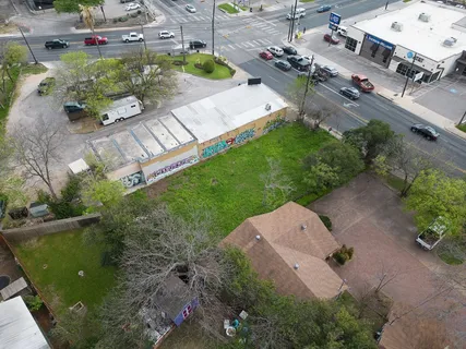 an aerial view of a house with a yard and outdoor seating