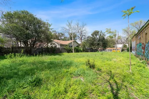 a view of a garden with a house in the background