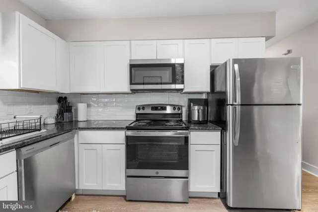 a kitchen with a stove microwave and refrigerator