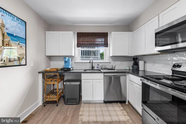 a kitchen with a stove a sink and a microwave