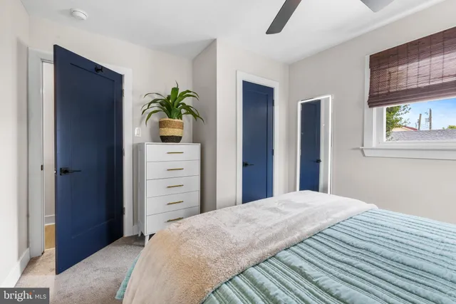 a large bedroom with a bed and a window