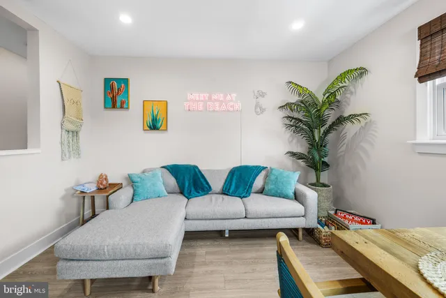 a living room with furniture and a potted plant