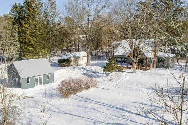 a view of the house with snow on the road