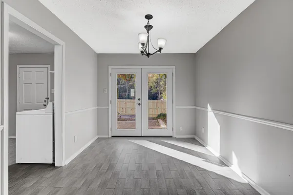 a view of an entryway with wooden floor