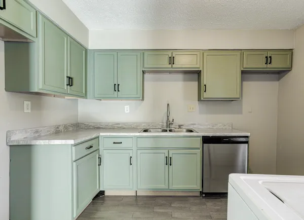 a kitchen with a sink and cabinets