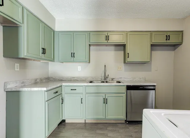 a kitchen with a sink and cabinets