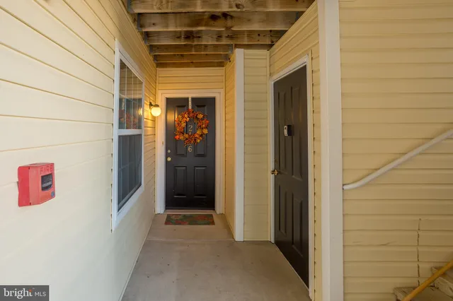 a view of kitchen with furniture and refrigerator