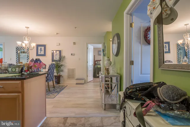 a kitchen with stainless steel appliances granite countertop a refrigerator a stove and a sink