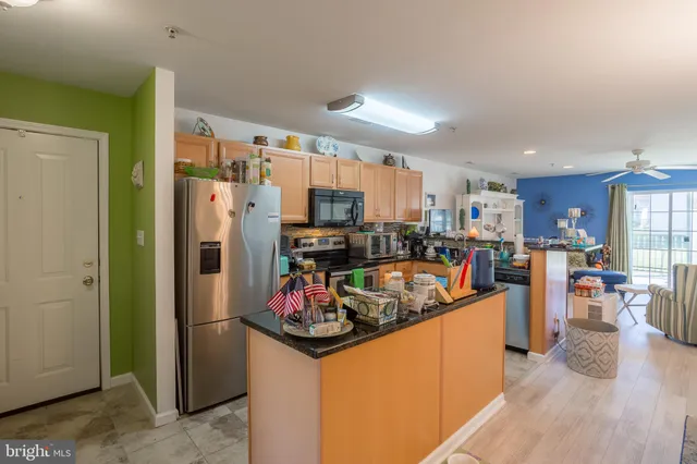 a kitchen with stainless steel appliances a stove a sink and a refrigerator
