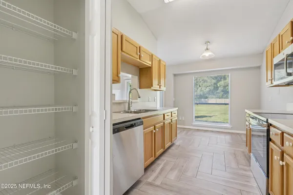 a kitchen with stainless steel appliances granite countertop a stove and a refrigerator