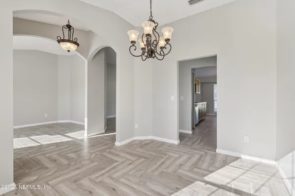 a view of a chandelier fan and wooden floor
