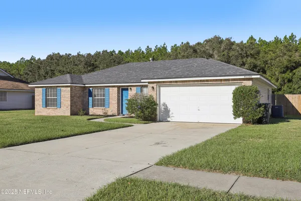 a view of a yard in front view of a house