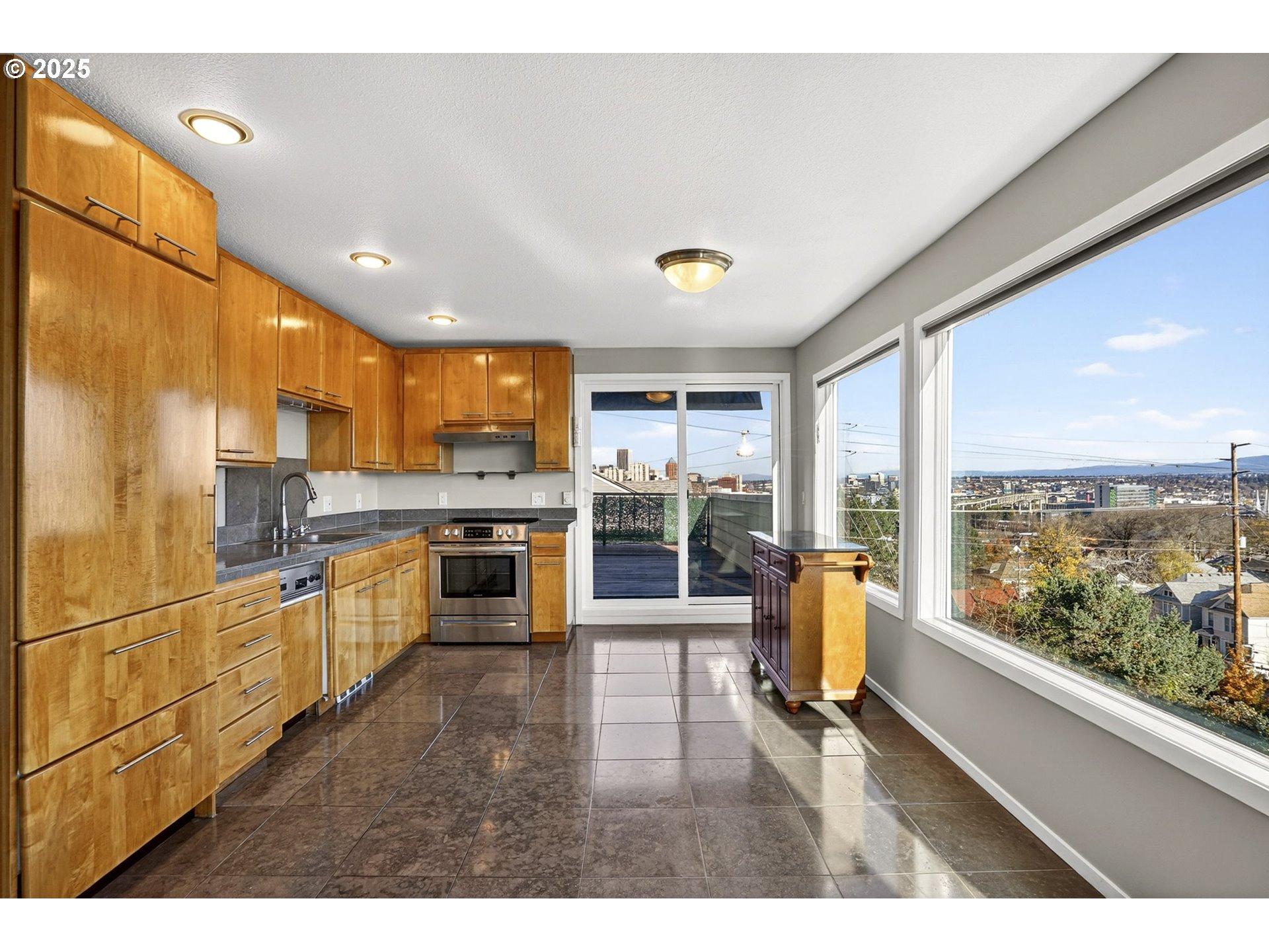 3515 Southwest Barbur Boulevard, Unit R2 Portland, OR 97239 - Photo 13 of 35 a living room with stainless steel appliances kitchen island granite countertop a refrigerator a sink dishwasher and wooden cabinets with wooden floor