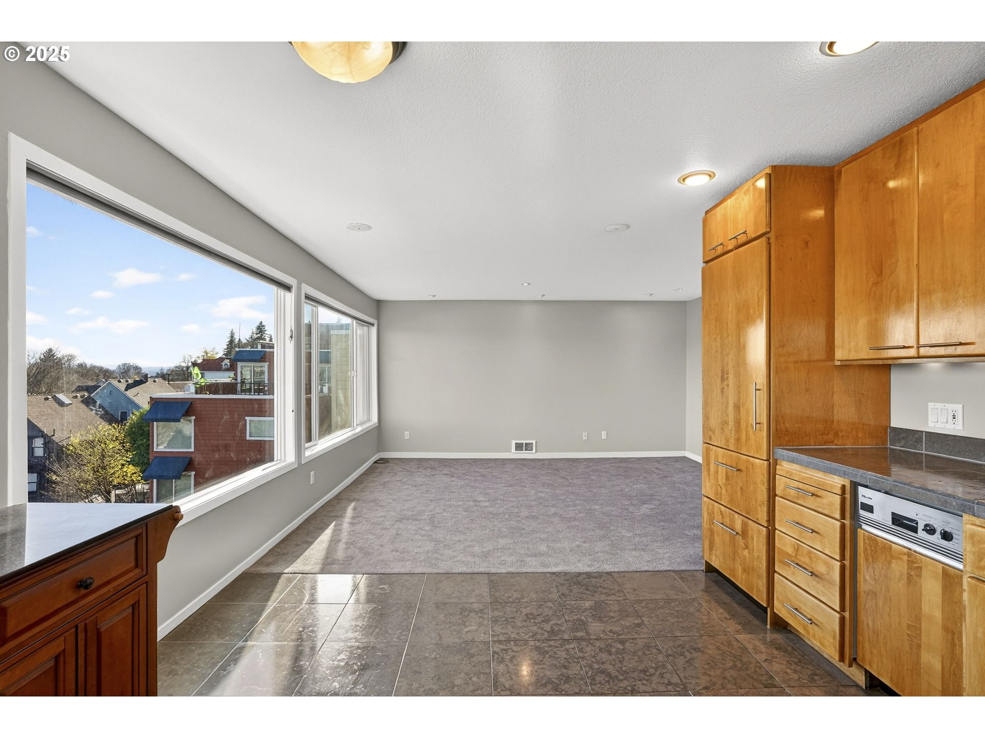 3515 Southwest Barbur Boulevard, Unit R2 Portland, OR 97239 - Photo 17 of 35 a open kitchen with stainless steel appliances granite countertop a refrigerator a stove and a sink with granite countertops
