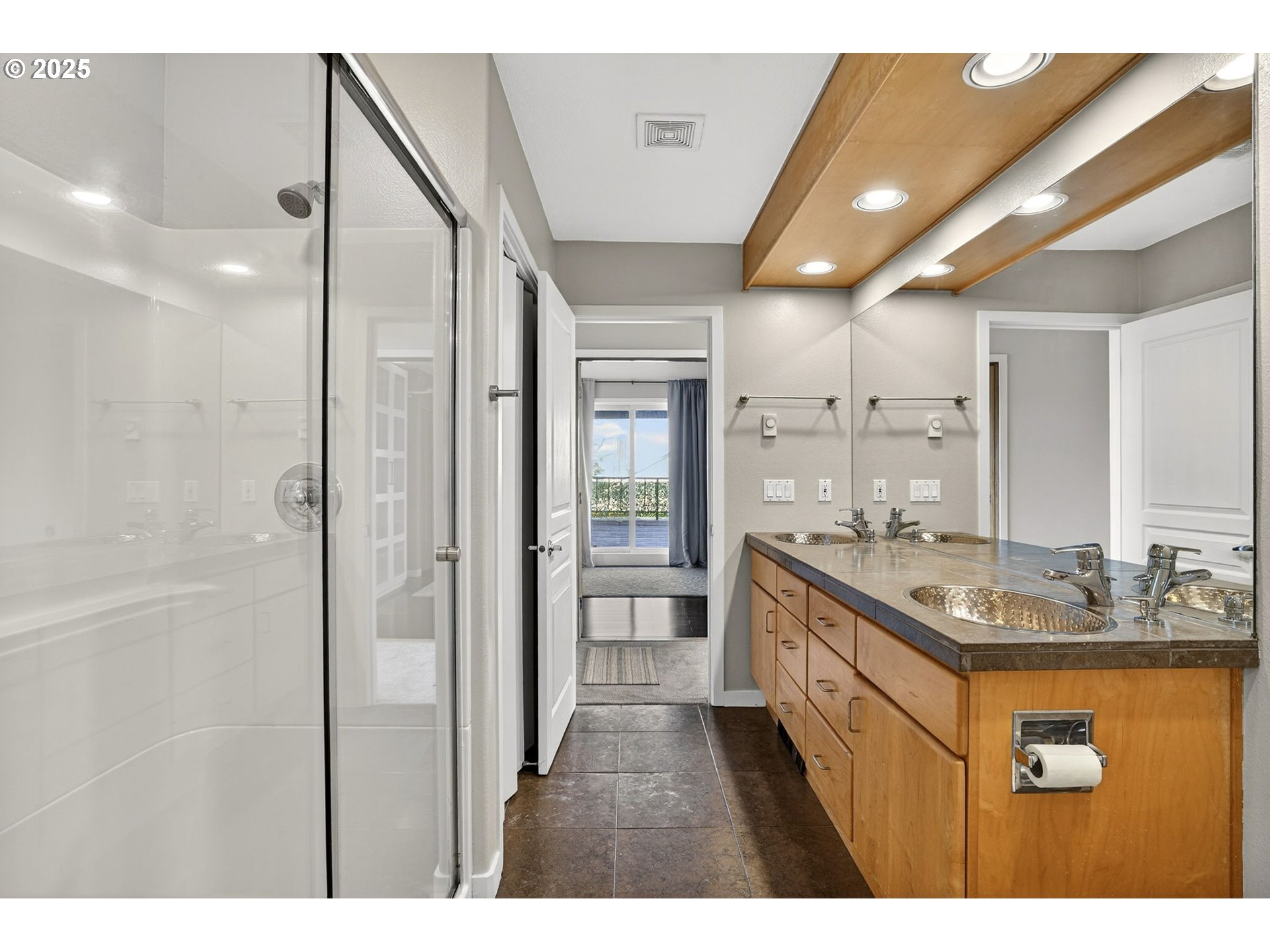 3515 Southwest Barbur Boulevard, Unit R2 Portland, OR 97239 - Photo 22 of 35 a bathroom with a granite countertop sink a mirror and a bathtub